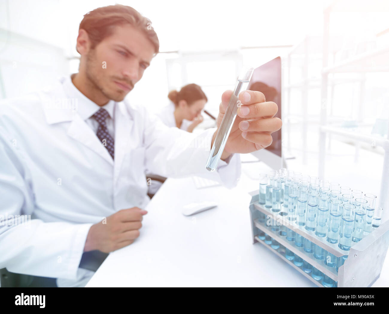 laboratory glass test tubes filled with liquid for an experiment in a ...