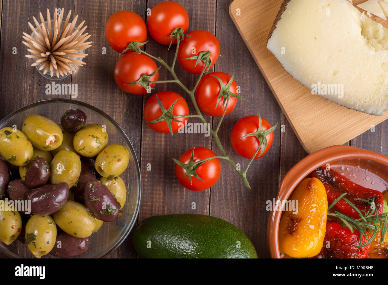 Mixed spanish tapas starters on table. Manchego cheese, olives and