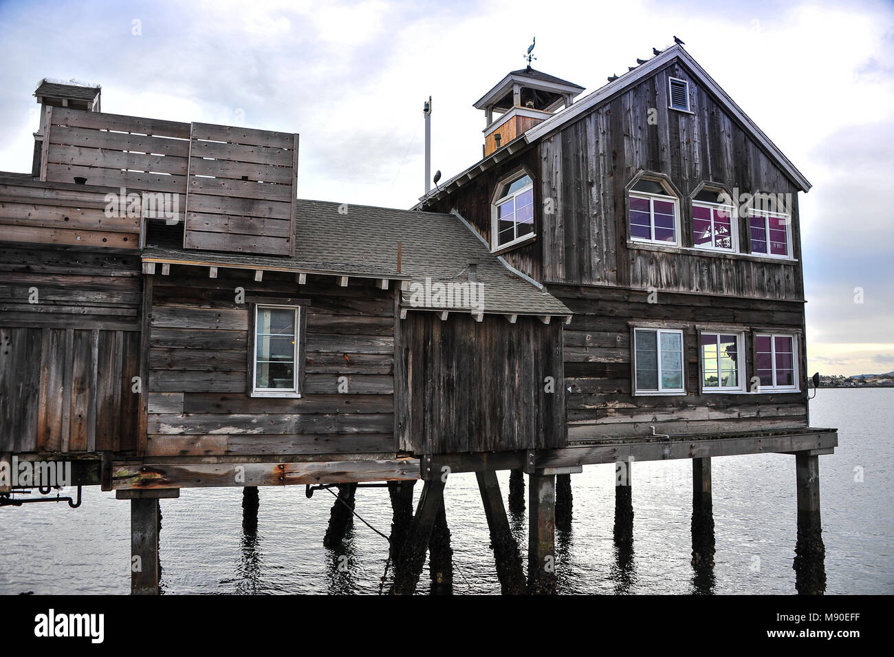 Timber stilt house sits over water at Seaport Village in San Diego, California. Stock Photo
