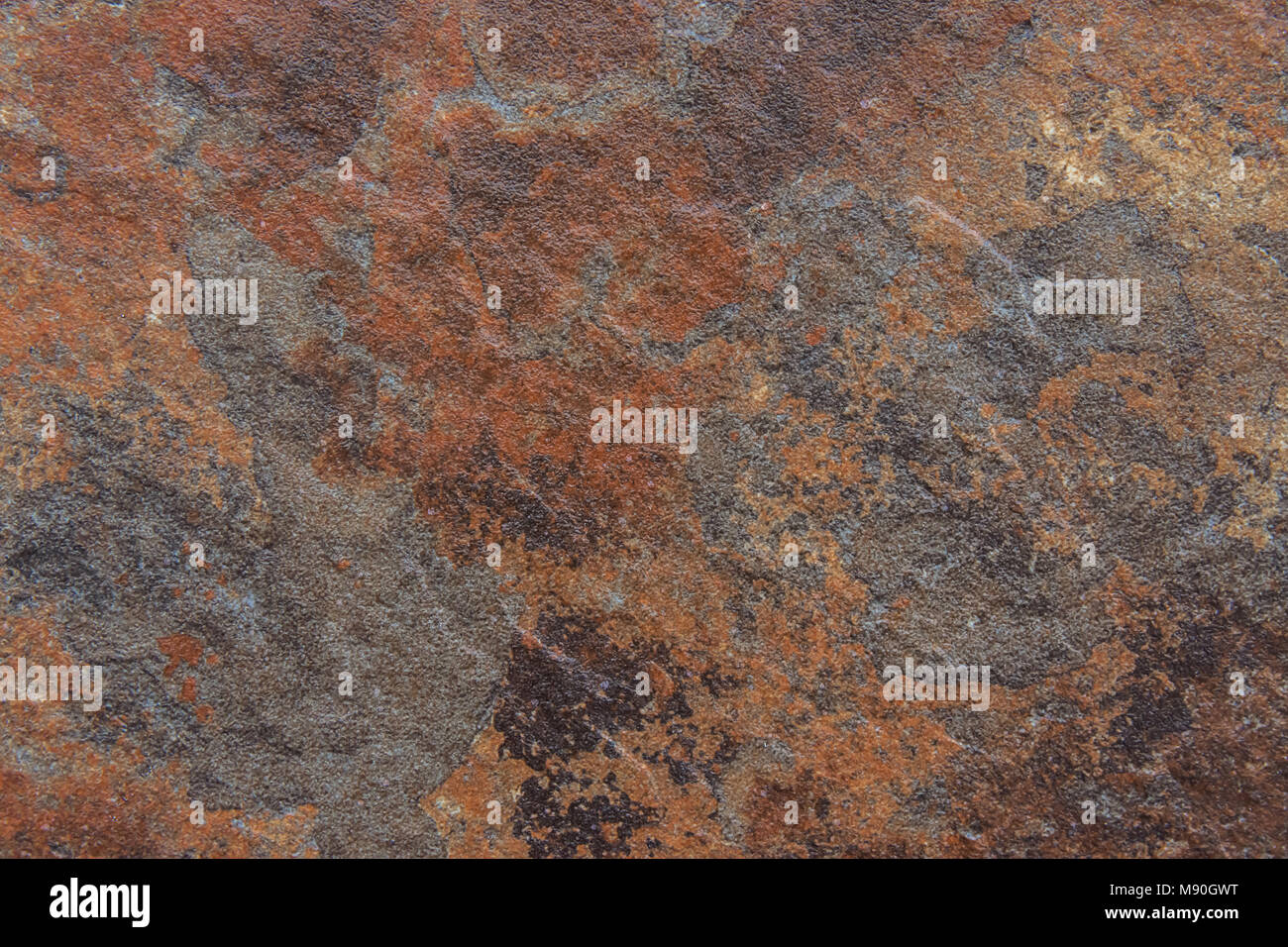 Old Distressed Brown Terracotta Copper Rusty Stone Background with Rough Texture Multicolored Inclusions. Stained Gradient Coarse Grainy Surface. Wall Stock Photo