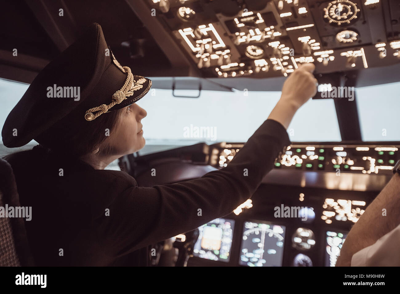Female pilot captain prepares for take-off plane Stock Photo