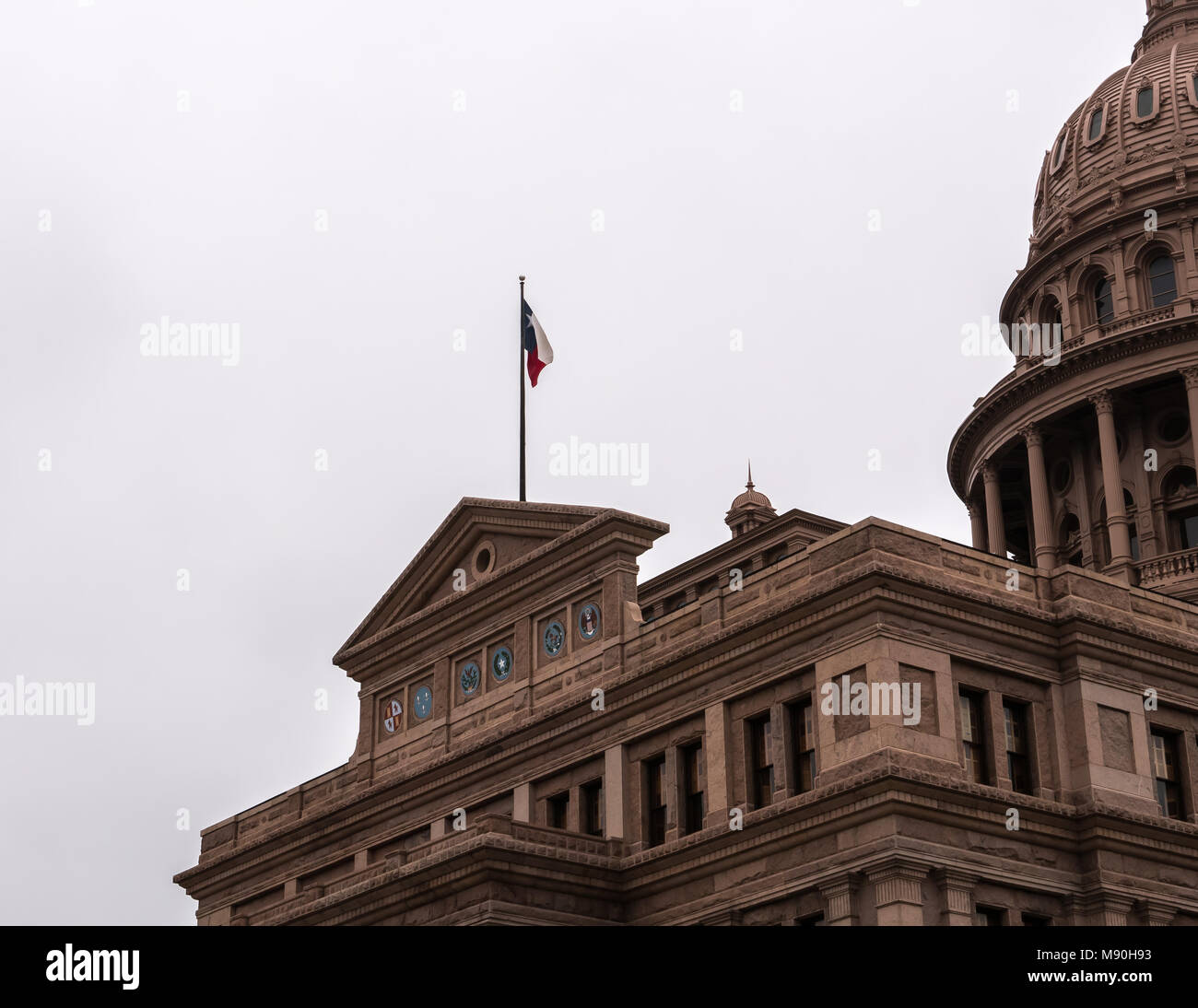 AUSTIN, TEXAS - DECEMBER 31, 2017: The iconic Lone Star state flag positioned on top of the front of the state Capitol building. Stock Photo