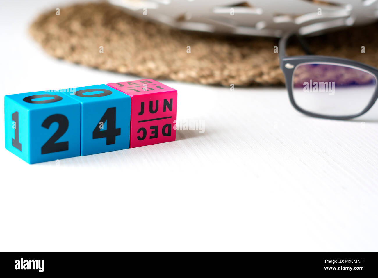 modern perpetual calendar composed of colored cubes and set at the date of June 24 Stock Photo