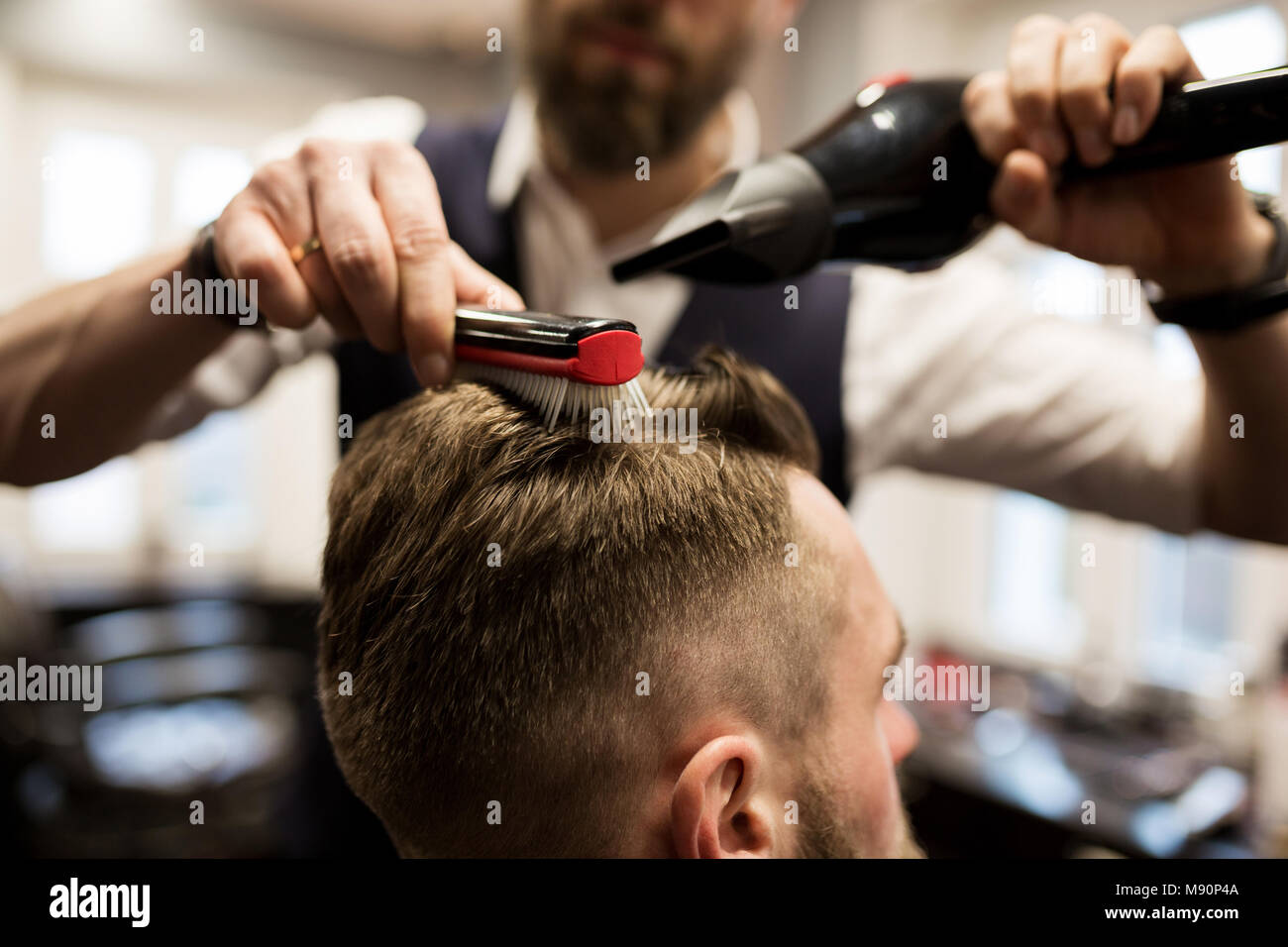 Cropped portrait of hairdresser drying customer hair Stock Photo - Alamy
