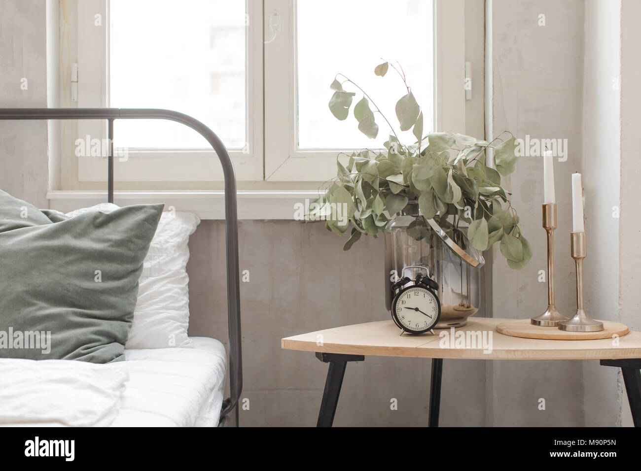 Bedroom interior clock plant pot on wooden table Stock Photo