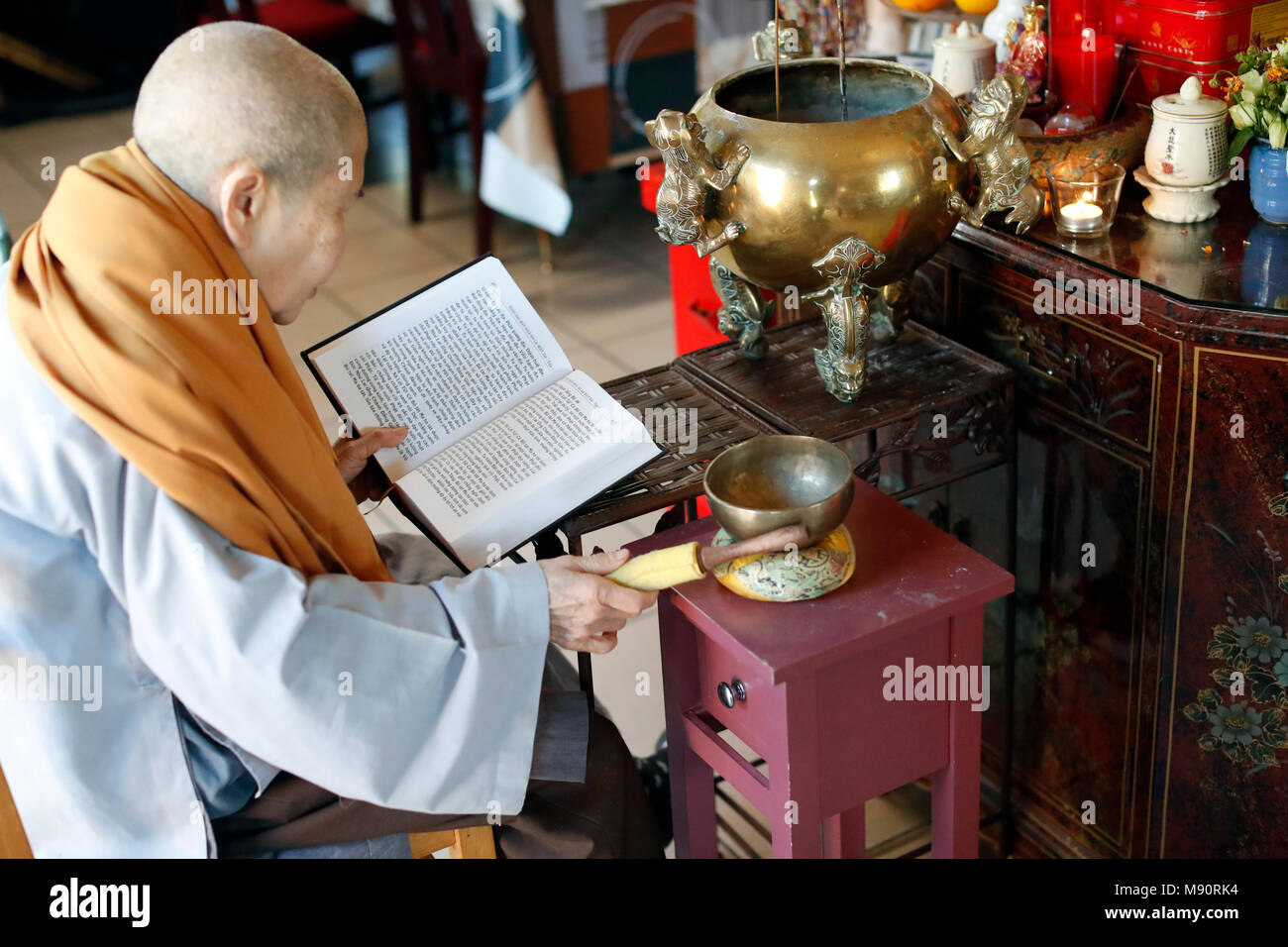 Tu An Buddhist temple. Monk at buddhist ceremony. Singing bowl Stock