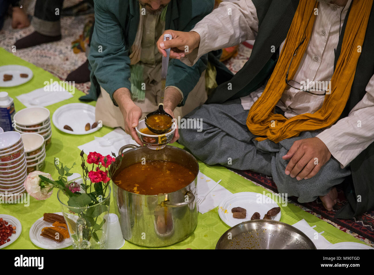 Sufi muslims sharing iftar (Ramadan dinner). Saint-Ouen, France. Stock Photo