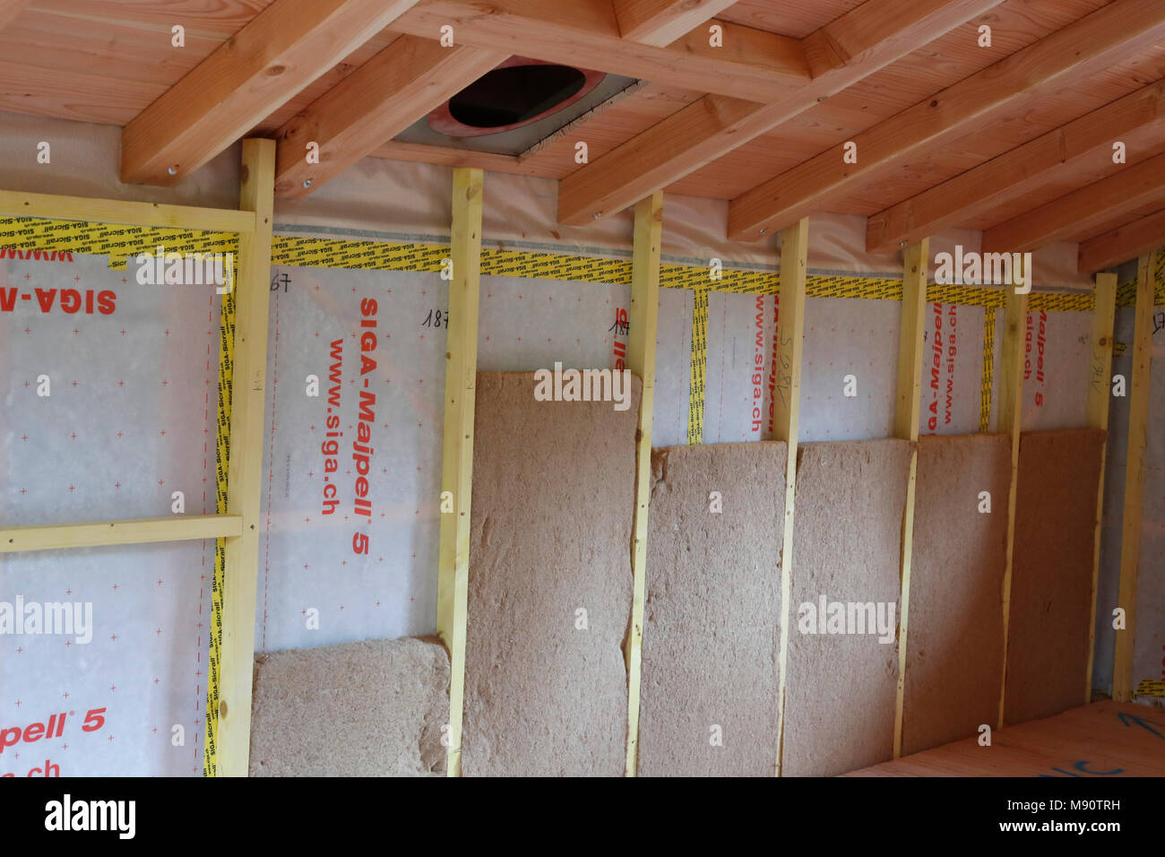 Wooden structure of house under construction. Insulation. Stock Photo