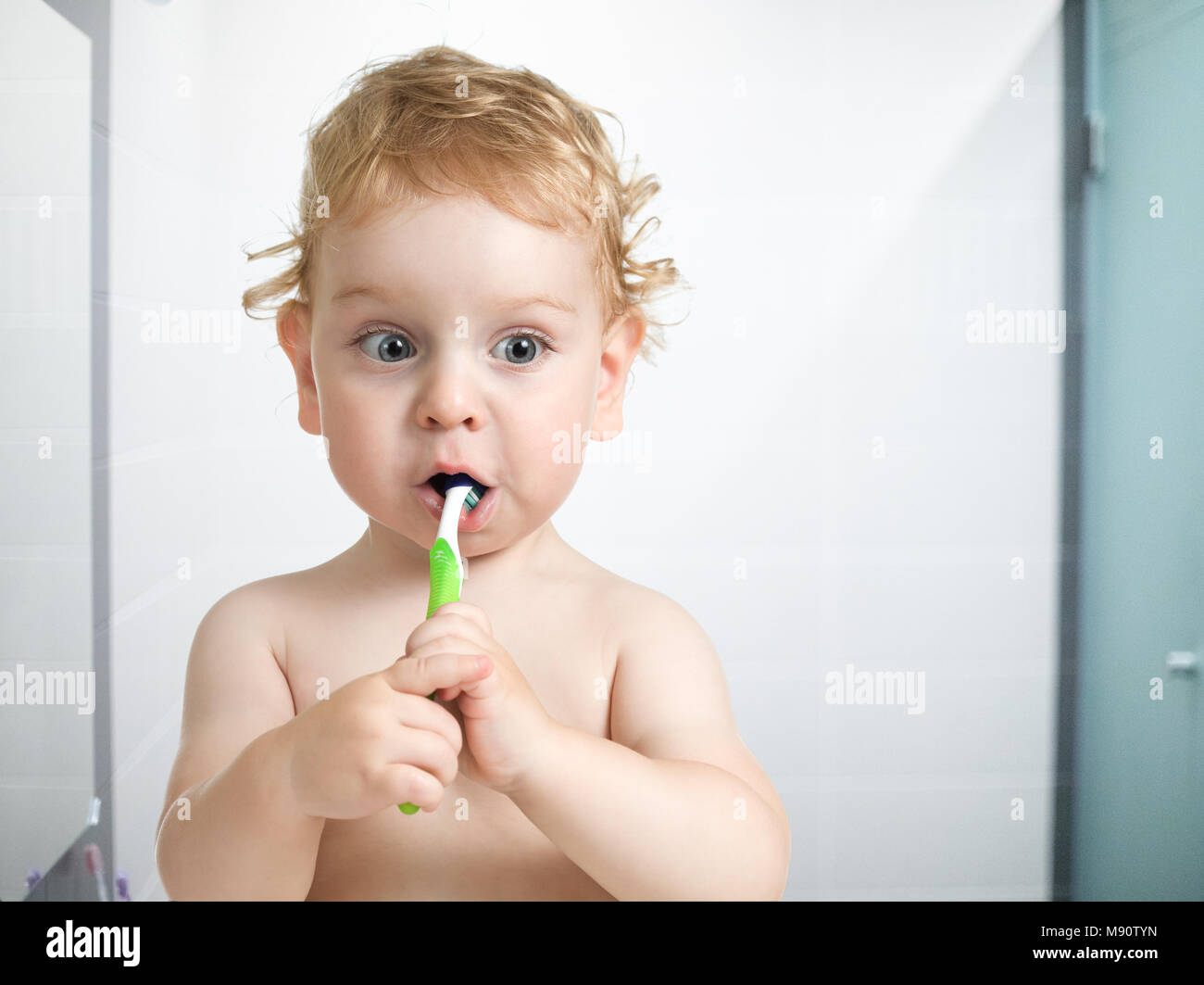 kid or child brushing teeth in bathroom Stock Photo