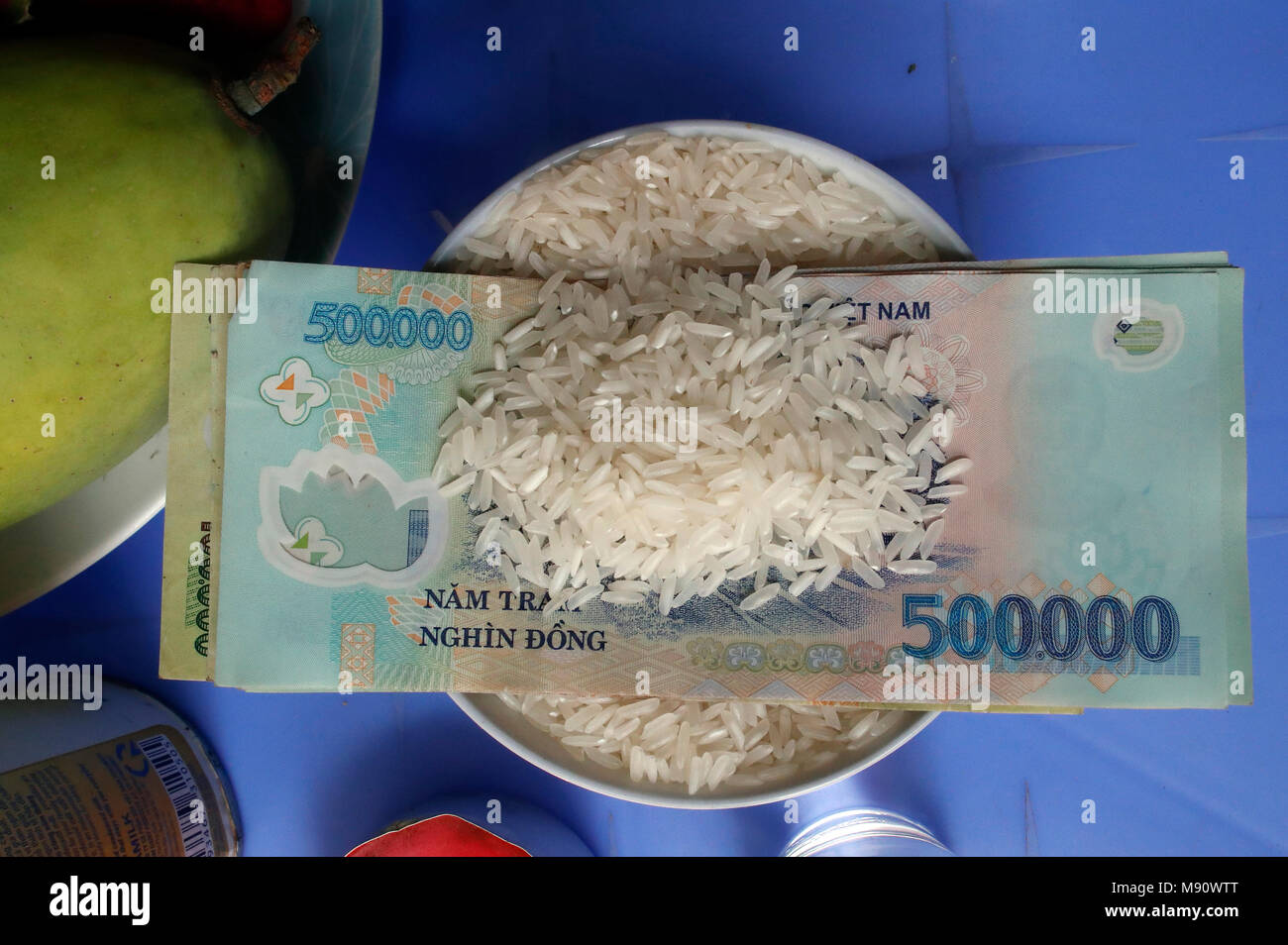 Buudhist offerings. Rice and bank note.  Ho Chi Minh City. Vietnam. Stock Photo