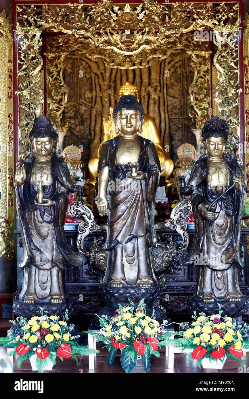 Chua Ho Quoc pagoda. Main altar. Buddha and Quan Am ( Goddess of Mercy ) staues. Phu Quoc. Vietnam. Stock Photo