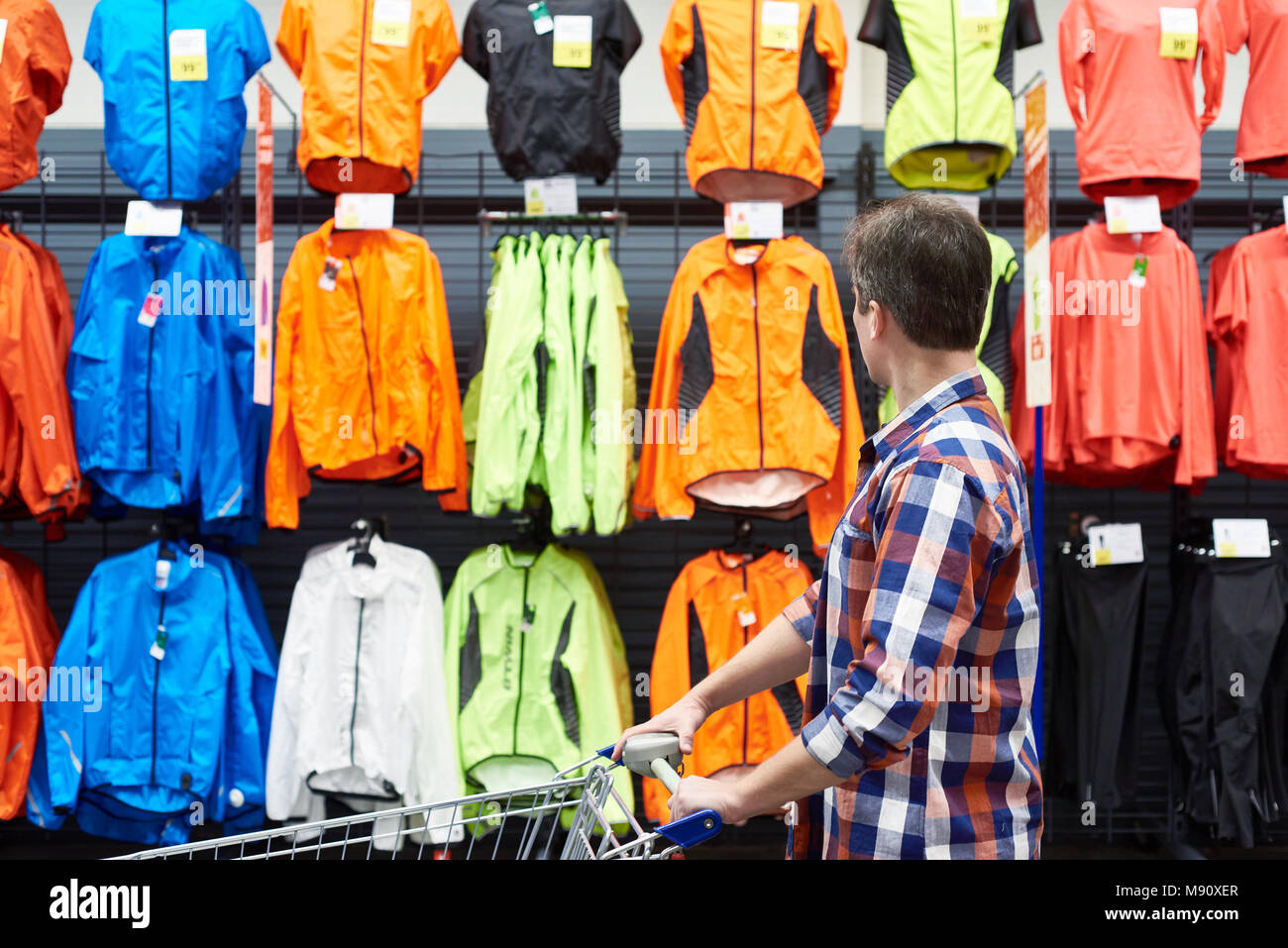 Man chooses sports clothes in a store Stock Photo Alamy