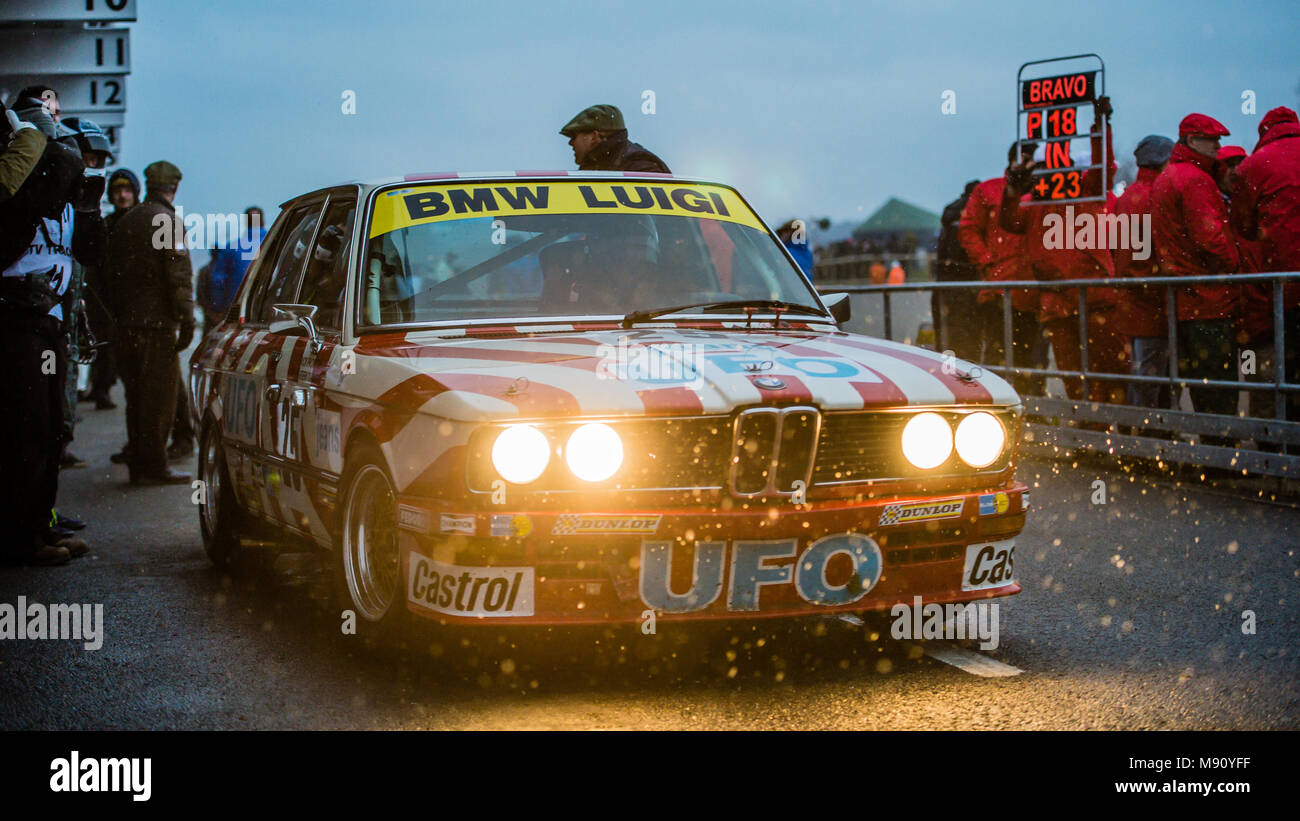 Nick Padmore leaves the Pit Lane in the UFO Jeans liveried BMW 530i during the Gerry Marshall at Goodwood Members Meeting 76 at Goodwood Motor Circuit Stock Photo