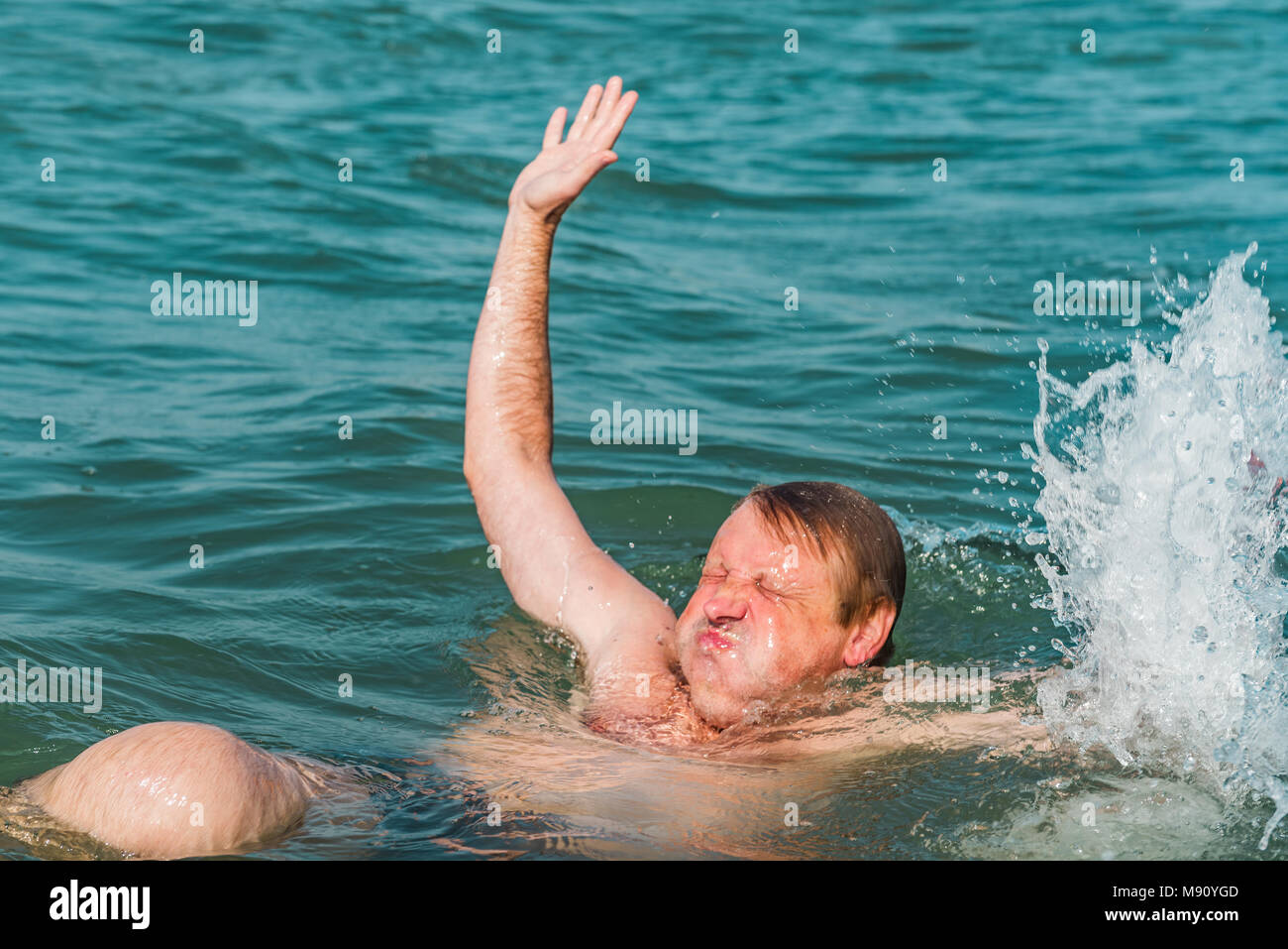 A sinking person, the salvation of a drowning man Stock Photo