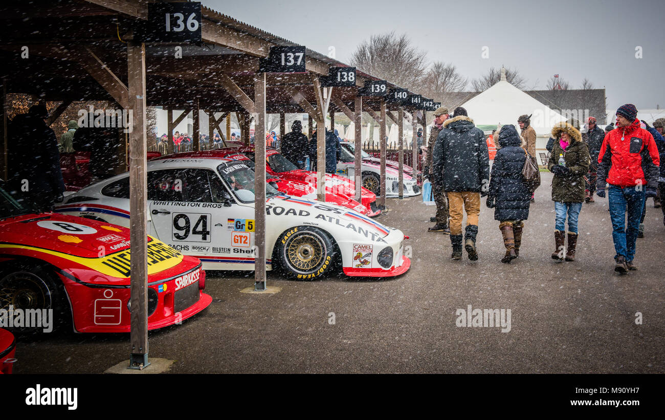 Awesome Porsche Group 5 cars sit in the paddock during Goodwood Members Meeting 76 as the snow falls for the first ever time at Goodwood Motor Circuit Stock Photo