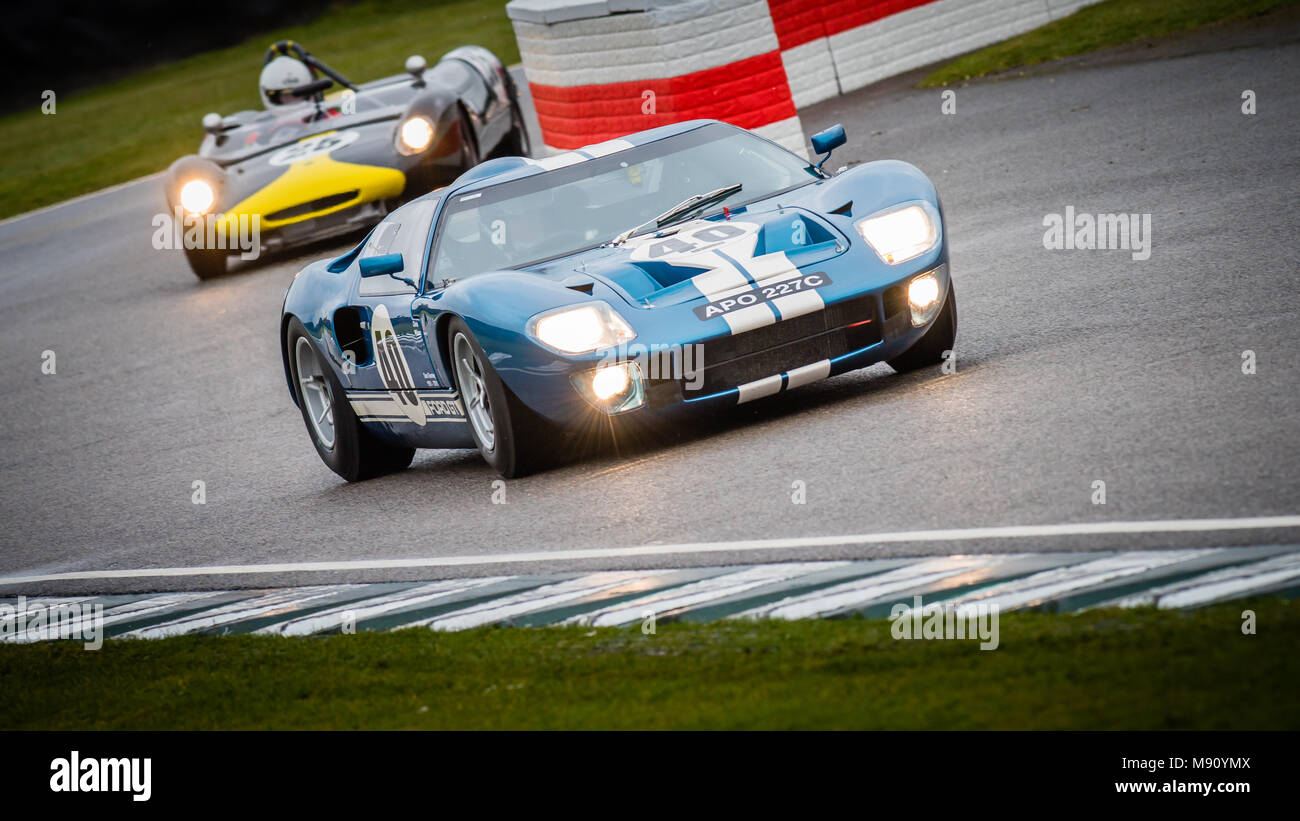 1965 Ford GT40 exits out of the chicane ahead of the 1963 Lotus-Ford 23B at the 2018 Goodwood Members Meeting, 76MM Stock Photo