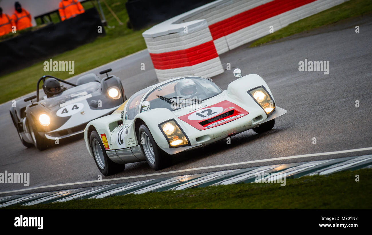 1966 Porsche 906 heads the 1964 McLaren-Chevrolet M1A out of the chicane at the 2018 Goodwood Members Meeting, 76MM Stock Photo