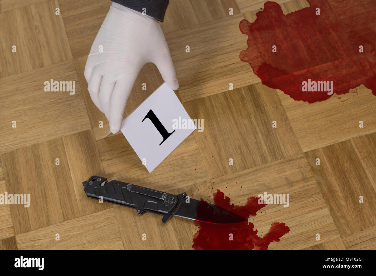 Crime scene investigation, evidence markers on wooden flor with knife and blood. Murder, kill and forensic evidence concept Stock Photo