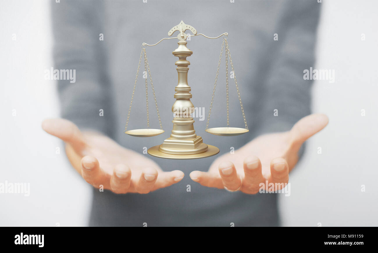 Scales of justice, weight of justice on hand, law Stock Photo