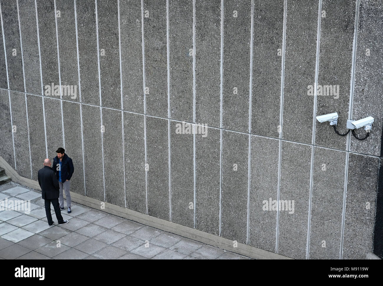 Two men and security cameras on the South Bank in London. Stock Photo