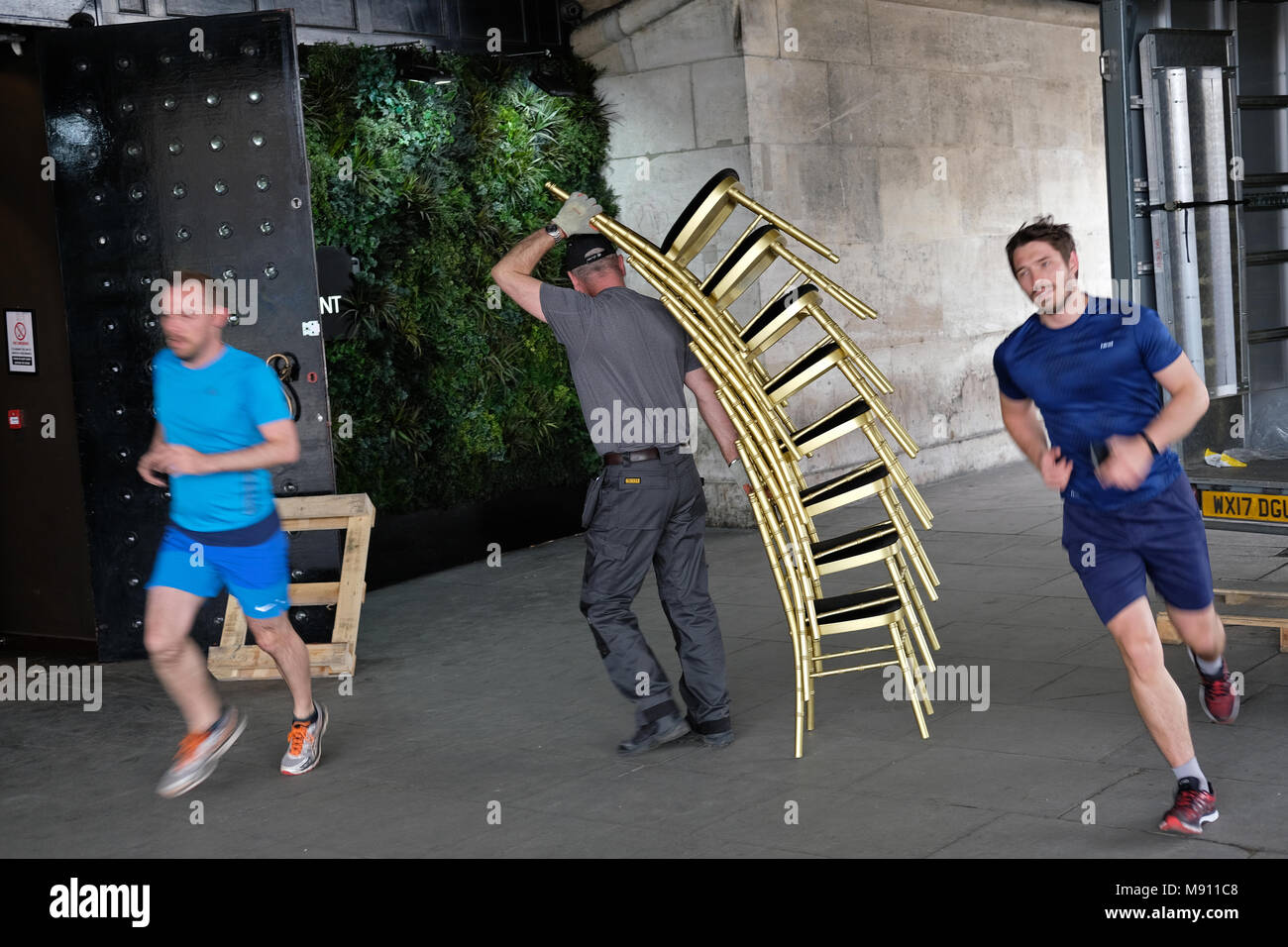 A man carrying a difficult load. Stock Photo