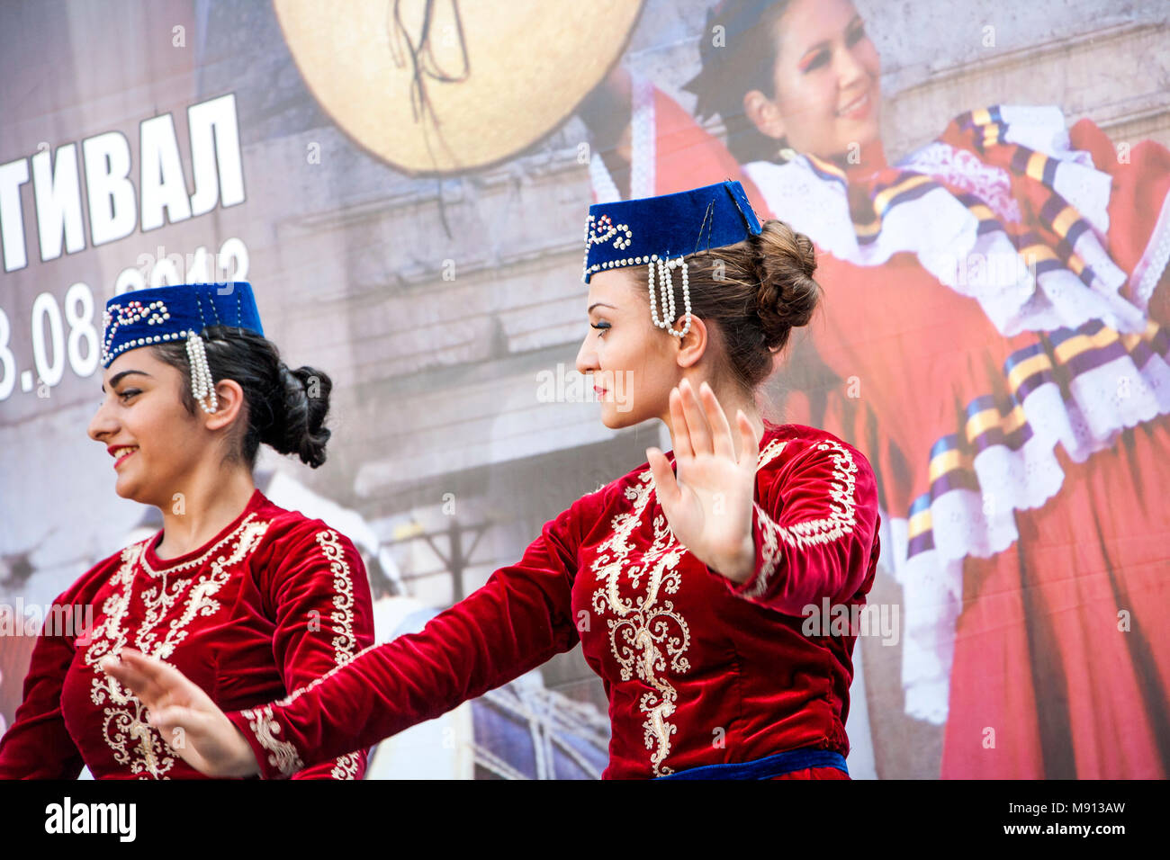 Plovdiv, Bulgaria - 3rd August 2013: Two Armenian girls in folklore costumes are performing on stage of the XIX International Folklore Festival Stock Photo