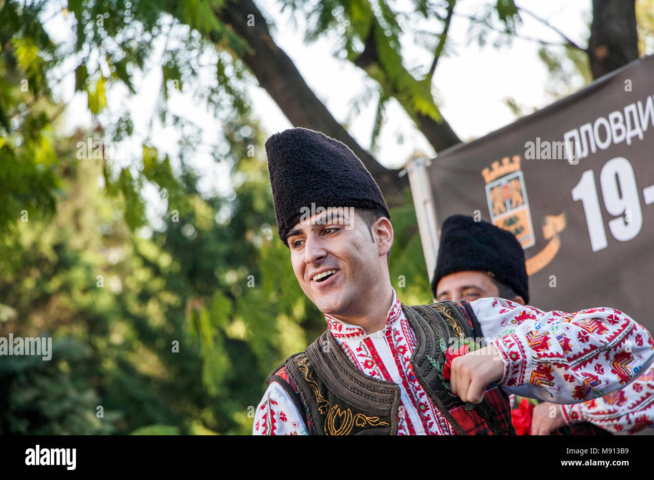 Plovdiv, Bulgaria 3 August 2013: Male folklore dancer in Bulgarian national costume is performing on stage of the XIX International Folklore Festival Stock Photo