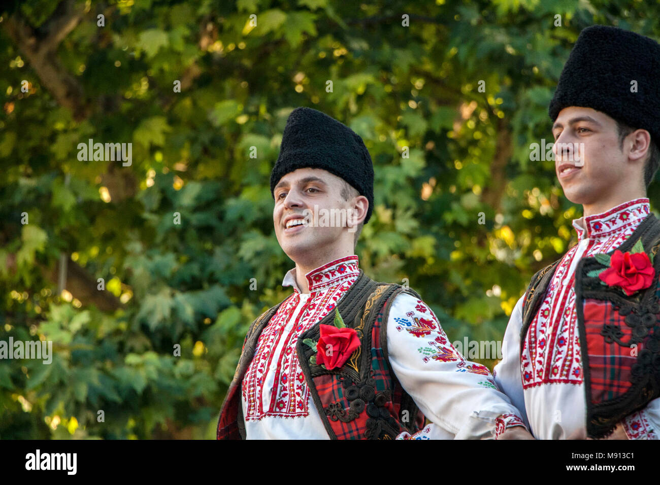 Plovdiv, Bulgaria 3 August 2013: Male dancers in Bulgarian national costumes are performing on stage of the XIX International Folklore Festival. Stock Photo