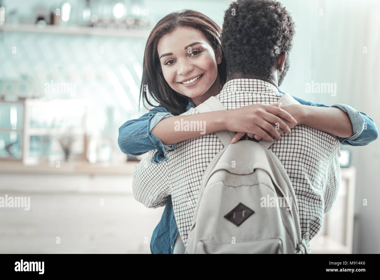 Delighted positive woman hugging her friend Stock Photo