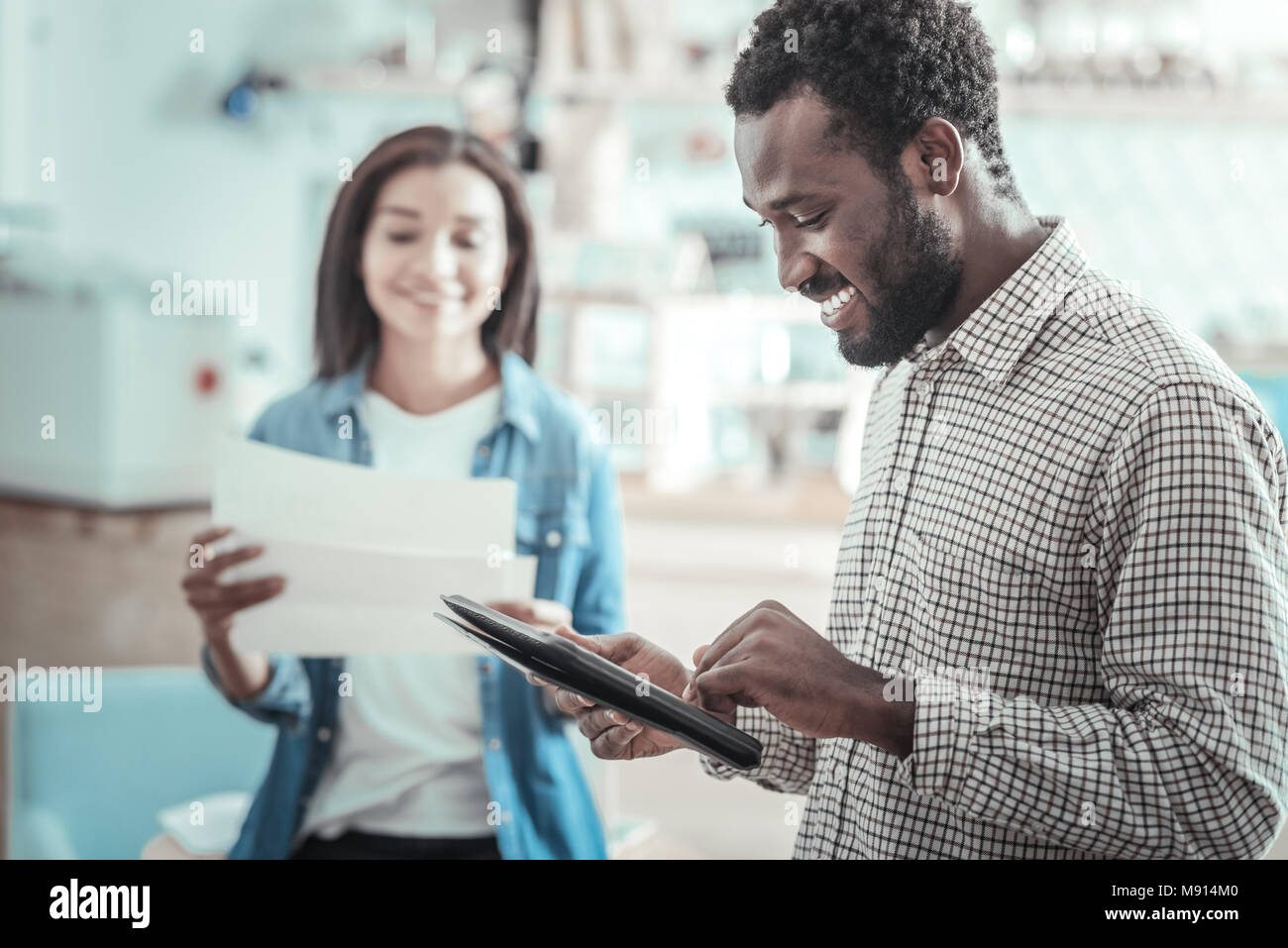 Young Man Using Tablet Happy young man using a tablet Stock Photo - Alamy