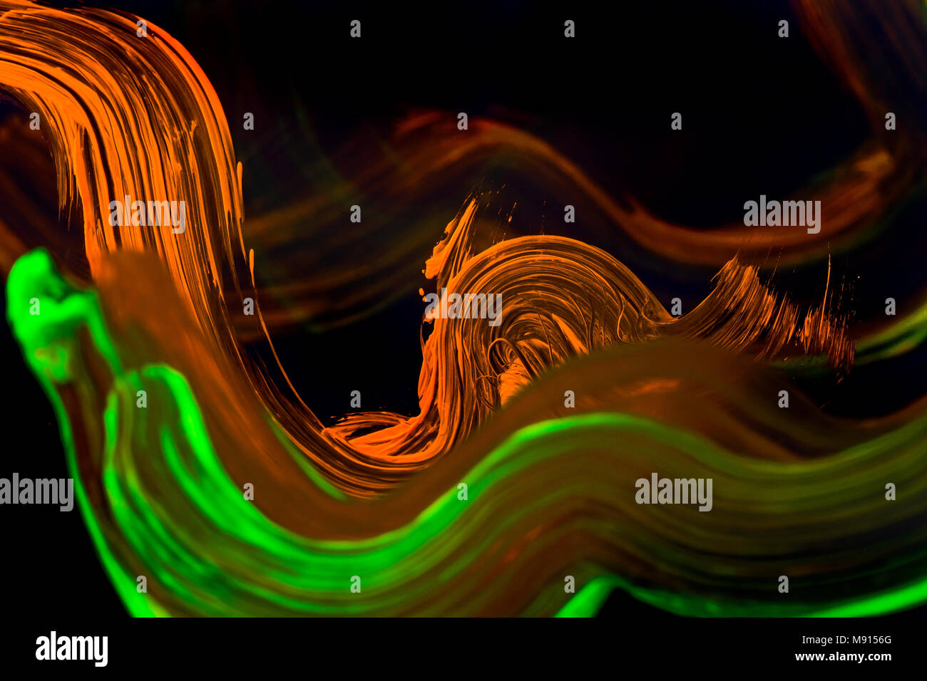 Abstract paint brush on the clear glass with light from neon. Stock Photo