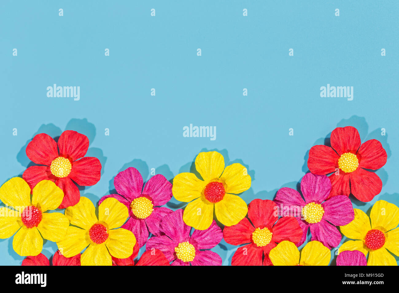 Paper flowers on the blue background Stock Photo - Alamy