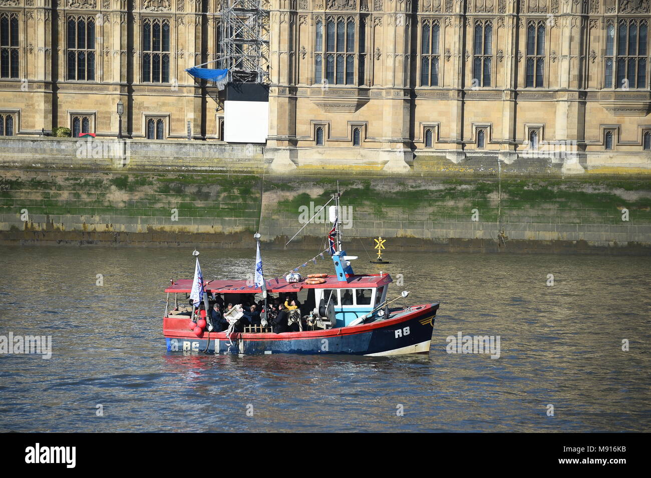 The Fishing for Leave boat passes the Houses of Parliament on the River Thames in London, during a Fishing for Leave protest where fish will be discarded into the Thames. Stock Photo