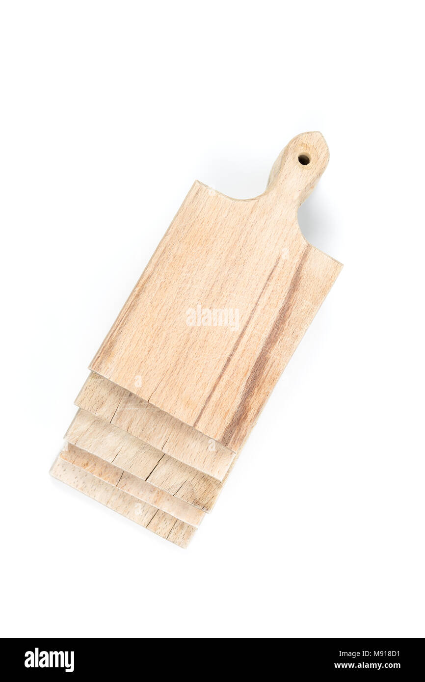 Set of used brown wooden cutting boards stack on each other on white