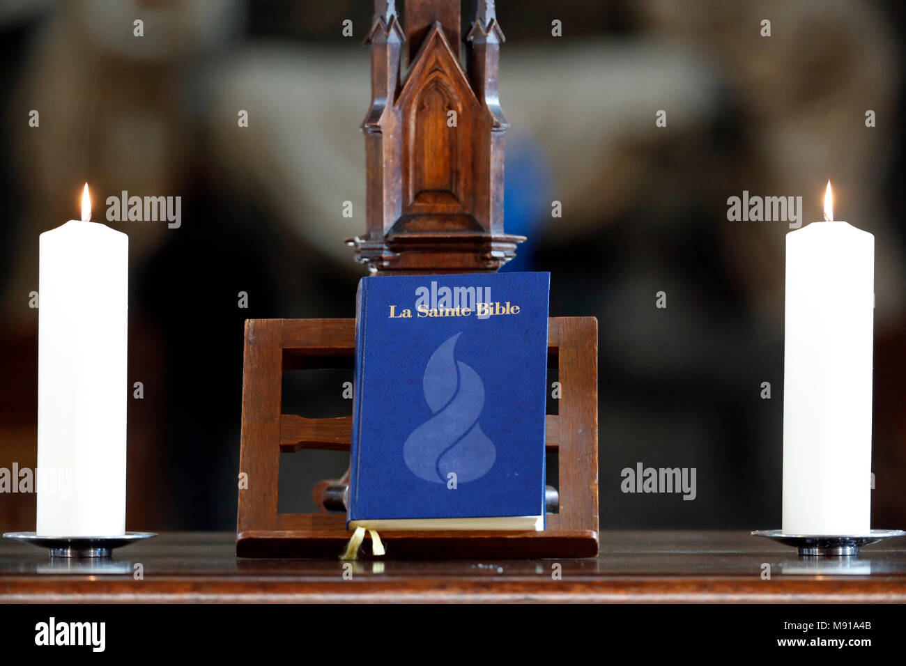 Church candles and  bible on an altar.  Strasbourg. France. Stock Photo