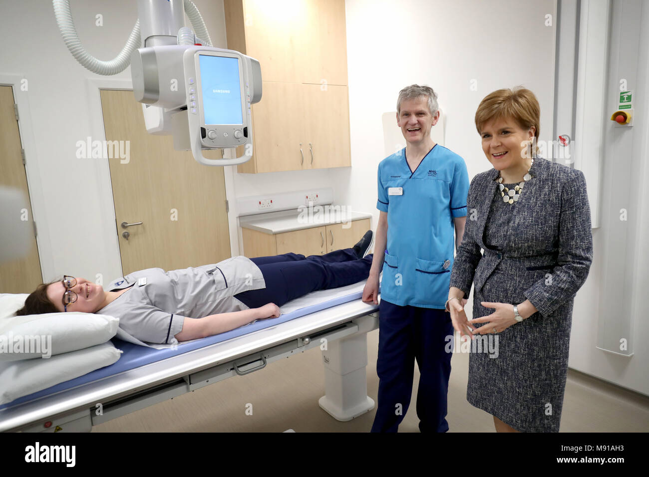 First Minister of Scotland Nicola Sturgeon meets radiography student Sarah Hallissey and senior radiographer Colin Anderson in the x-ray suite during a visit to the Out-Patients Department at the new East Lothian Community Hospital in Haddington. Stock Photo