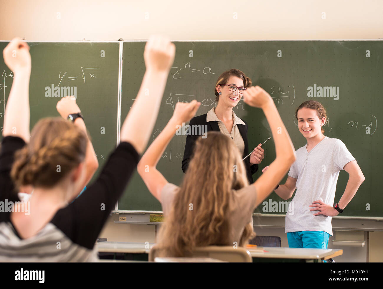 Math teacher standing in front of students who are well prepared Stock Photo