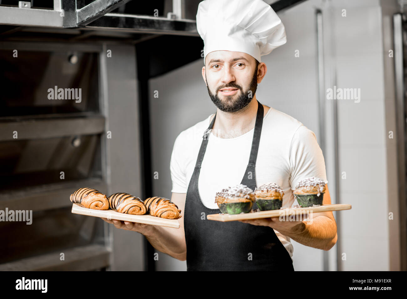 Confectioner with sweet pastry in the manufacturing Stock Photo