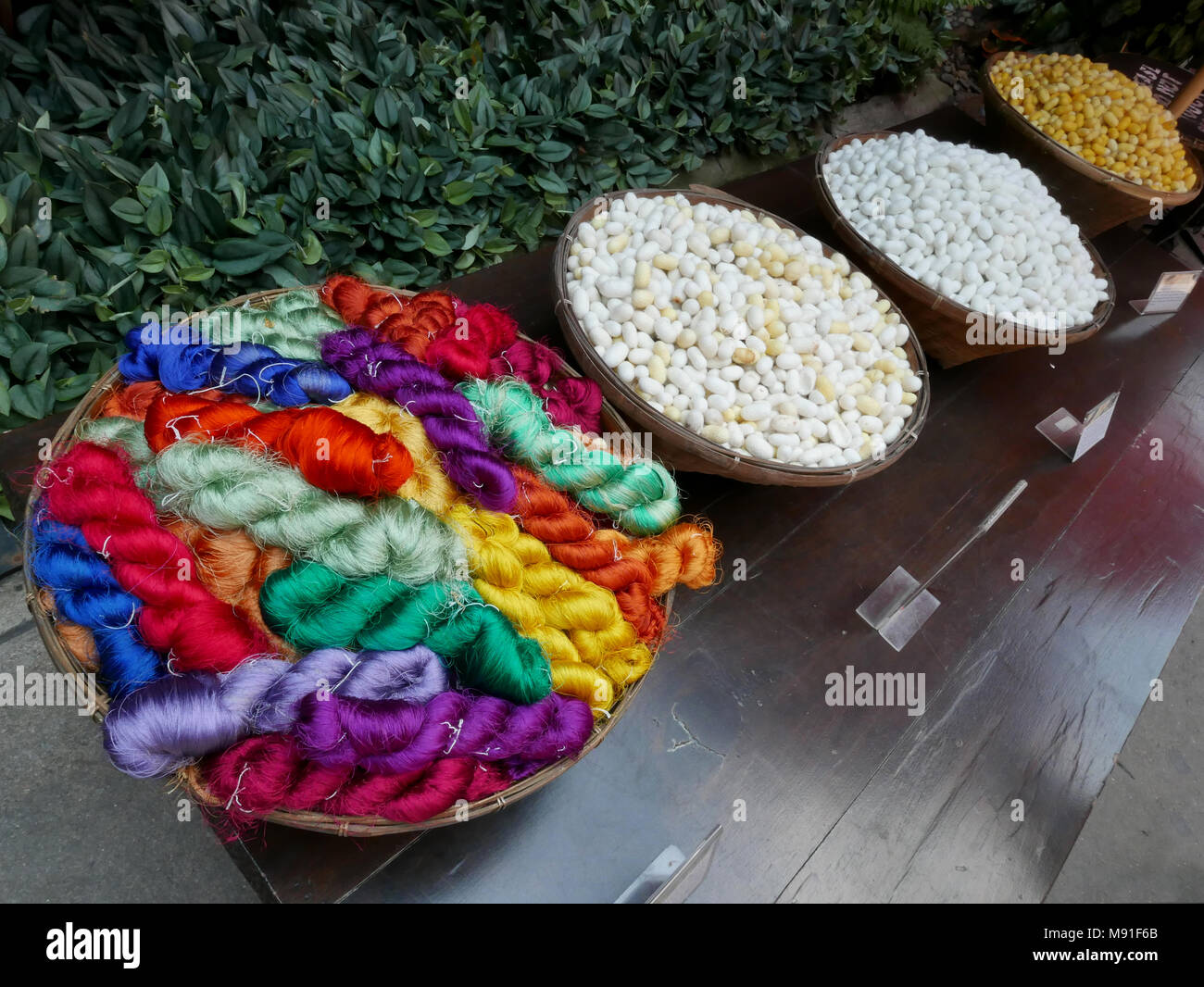 Silk cocoons and brightly colour silk thread at Jim Thompson's House in Bangkok, Thailand Stock Photo