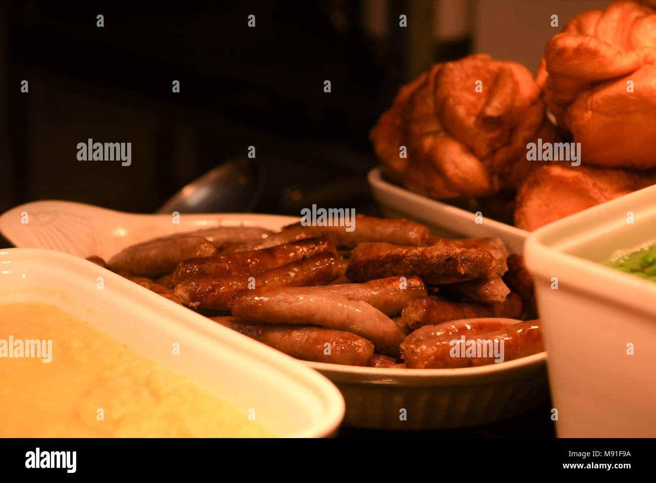 cooked chipolata sausages for a roast turkey or chicken dinner Stock