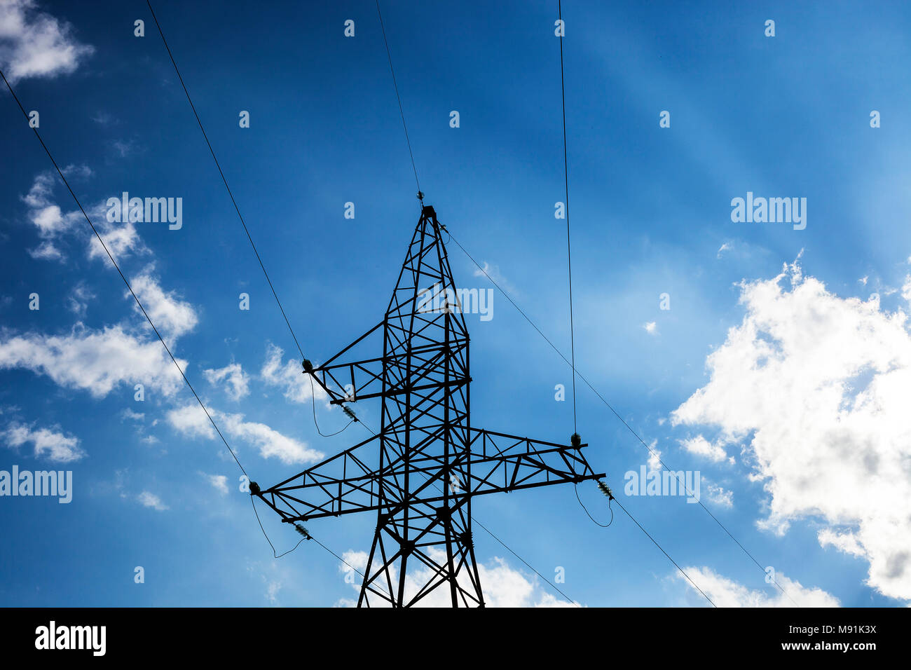 Electric pole high voltage isolated on cloudy blue sky Stock Photo