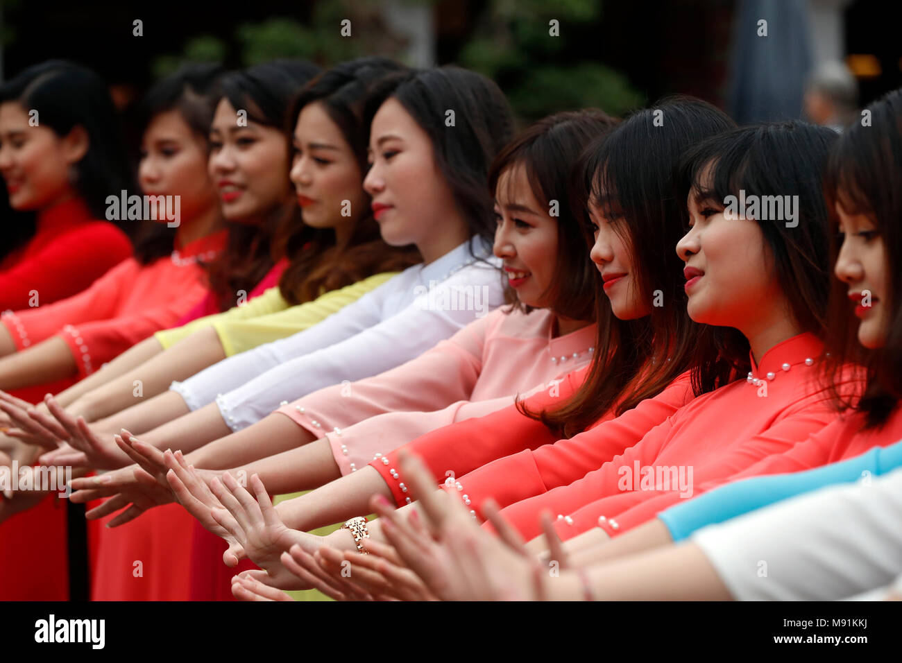 Vietnamese graduates wearing tradional dress, Ao Dai at Temple of Literature Hanoi. Vietnam. Stock Photo