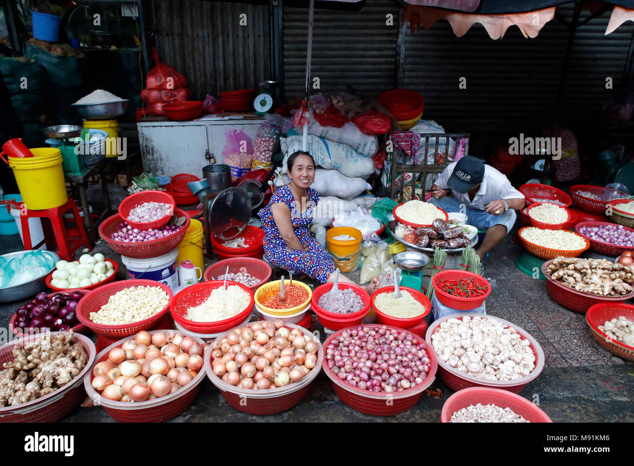 Street market. Woman selling onion and garlic.  Ho Chi Minh City. Vietnam. Stock Photo