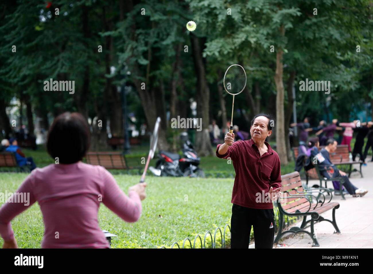 Badminton players  along the banks of Hoan Kiem lake.  Hanoi. Vietnam. Stock Photo