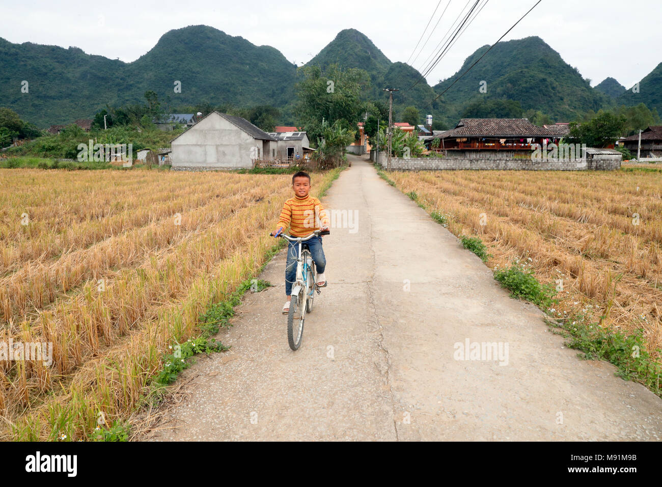 Rural life. Boy ridding bicycle.  Bac Son. Vietnam. Stock Photo