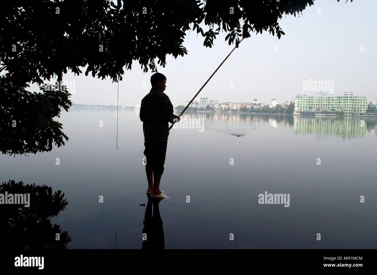 Man fishing on Ho Tay lake.  Hanoi. Vietnam. Stock Photo