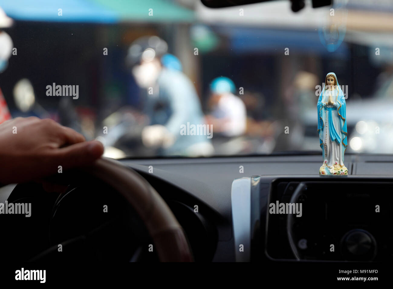 Virgin Mary figurine in a car.  Ho Chi Minh City. Vietnam. Stock Photo