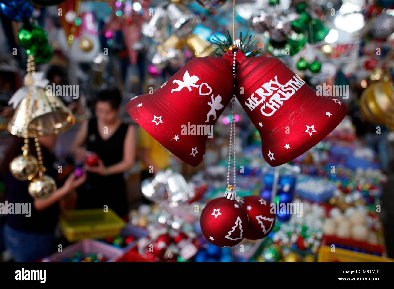 Vietnamese people shopping at market place to buy ornament for Christmas holiday.  Ho Chi Minh City. Vietnam. Stock Photo