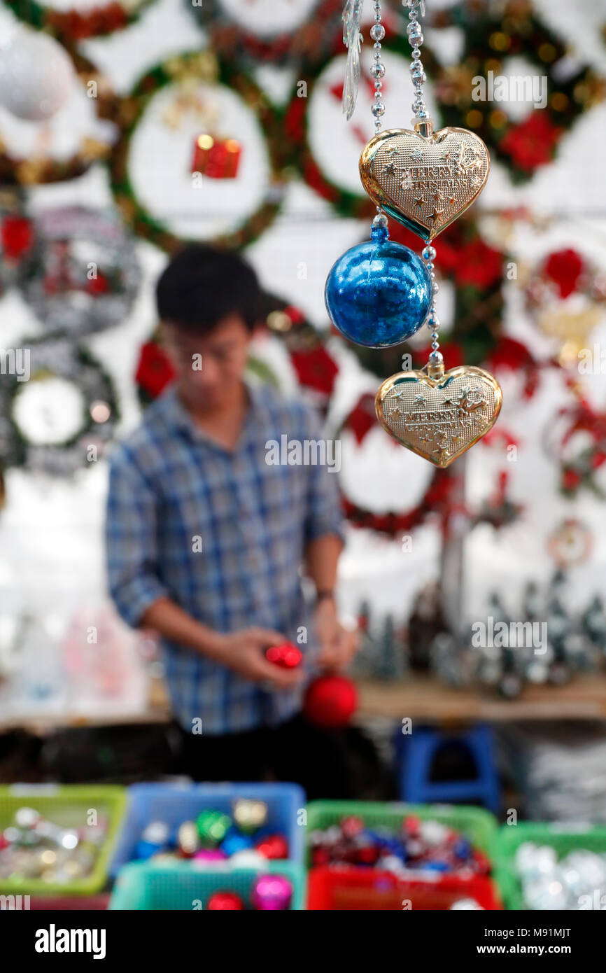 Vietnamese people shopping at market place to buy ornament for Christmas holiday.  Ho Chi Minh City. Vietnam. Stock Photo