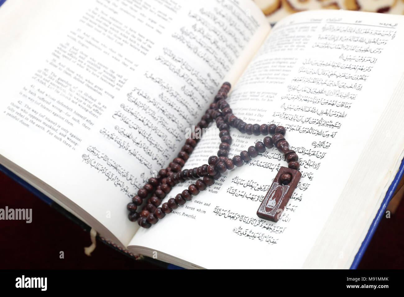 Holy Quran translated english version and muslim prayer beads. Stock Photo